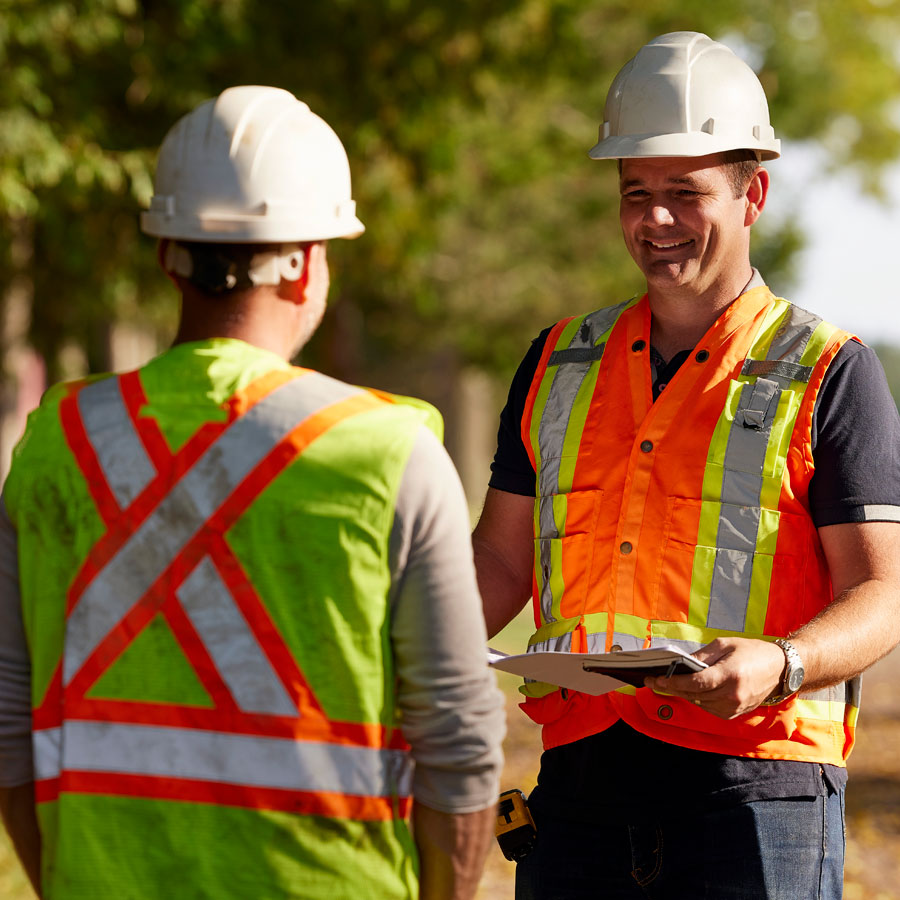 Advanced Excavating excavation contractor with niche capabilities and equipment discussing civil job site with the general contractor.