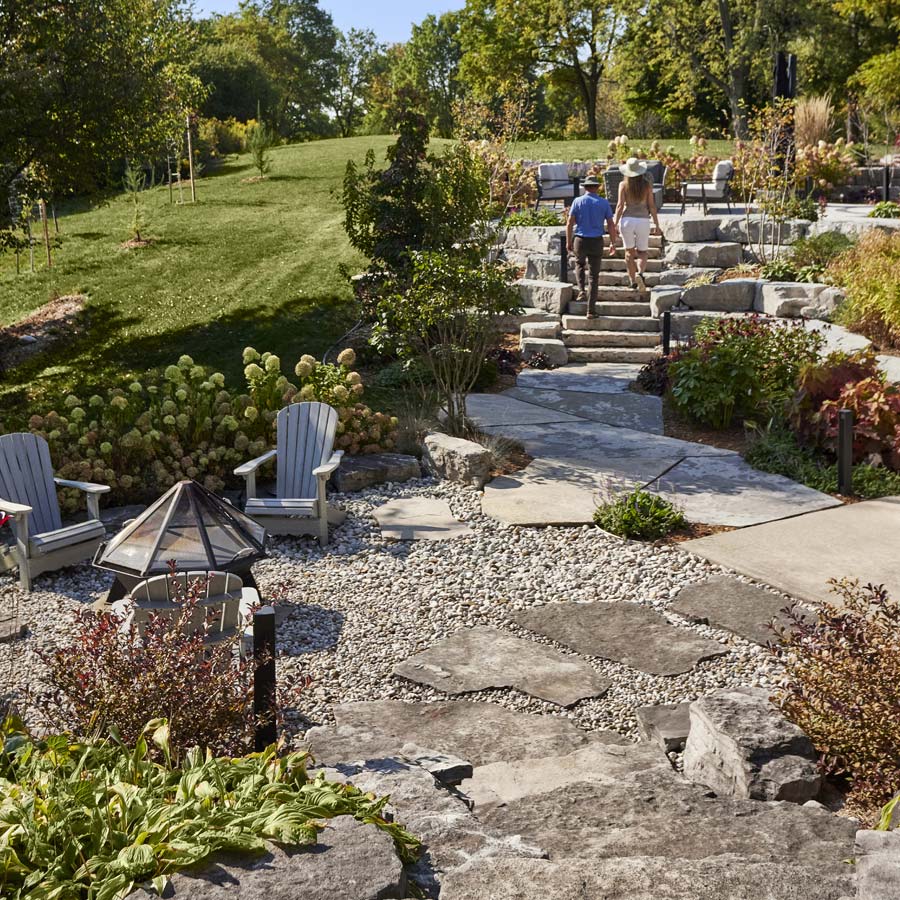 Homeowners enjoy their custom landscaping including excavated gardens and hardscape.